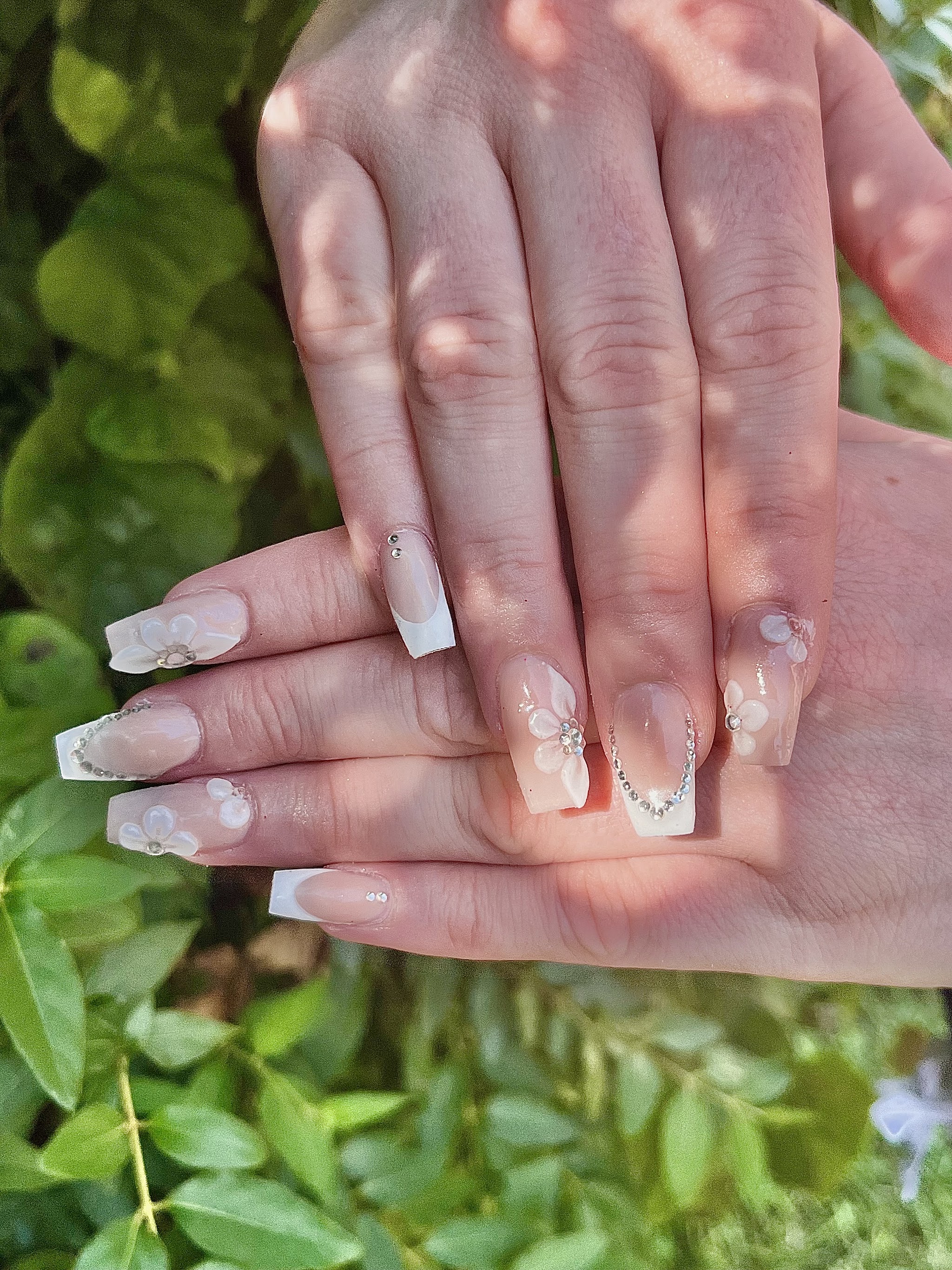 French tip nails photographed outdoors