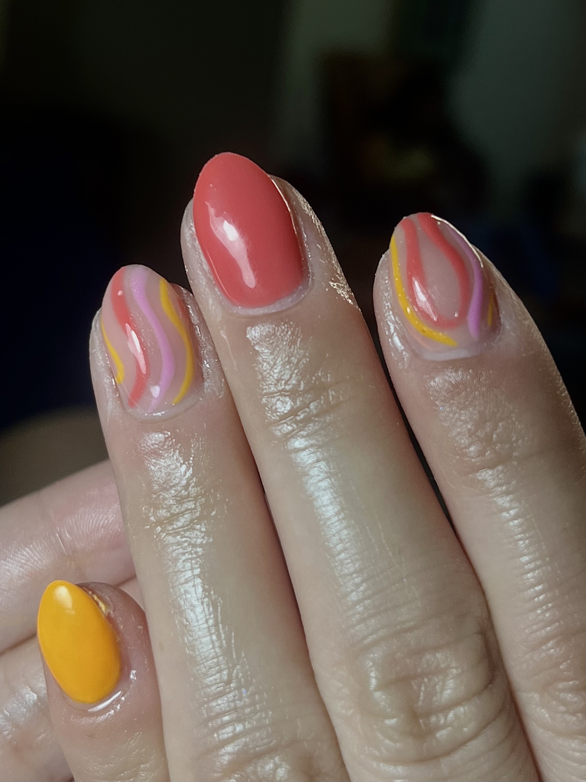 Natural nails with orange, pink and yellow swirl accents